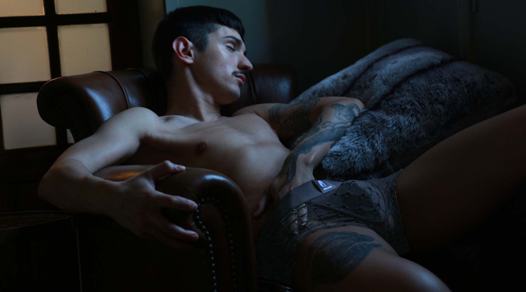 Male underwear model wearing Pothos Underwear while sleeping.