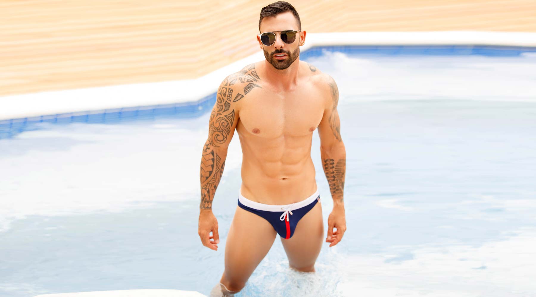 Male swimwear model wearing JOR Swim Thongs for Men